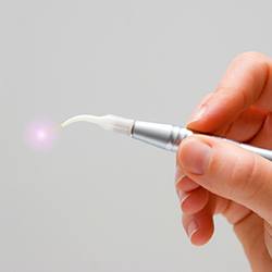 Hand holding a soft tissue laser