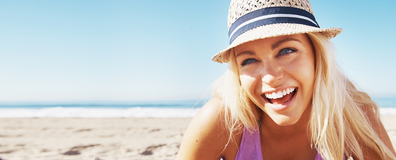 Young woman with flawless smile at the beach