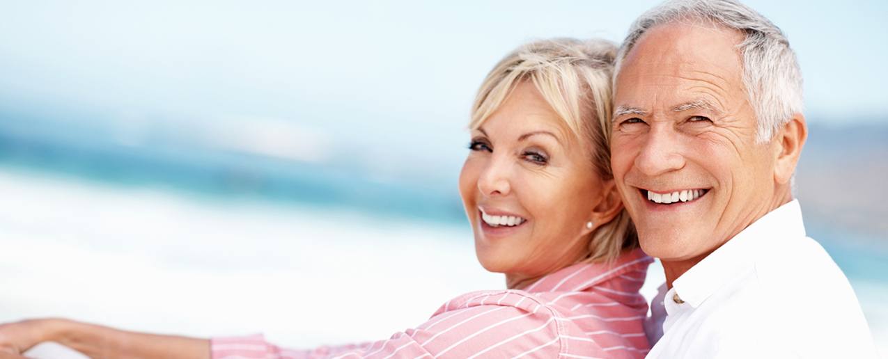 Smiling older man and woman at beach