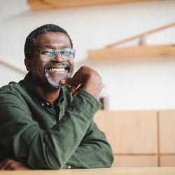 man smiling after getting dentures