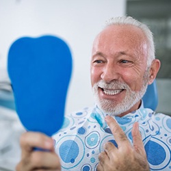 senior man admiring his new smile with dental implants in Myrtle Beach 