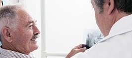 Smiling older man in dental chair