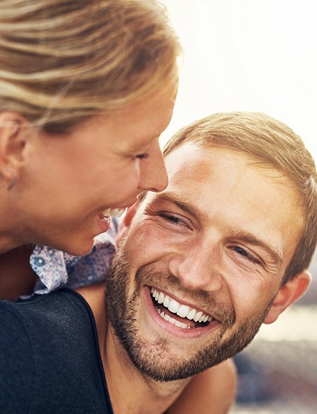 Smiling man and woman outdoors