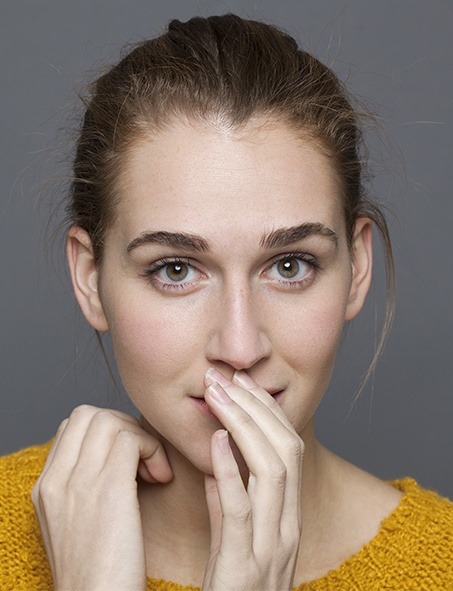 Woman covering her smile