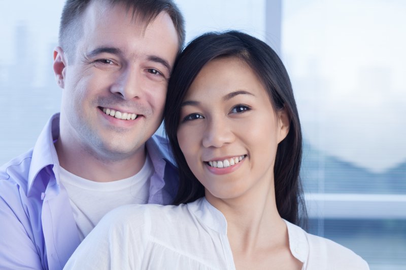 a male and female hugging and smiling