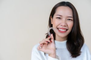 woman with Invisalign retainer