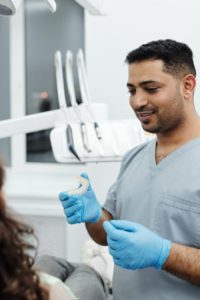 Dentist holding Invisalign aligner
