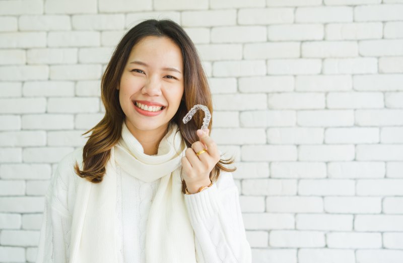 person holding an Invisalign tray